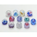 Twelve Caithness glass paperweights including miniature and Collectors' Club editions with