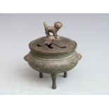 A bronze tripod censer / koro decorated with birds amongst bamboo friezes with Dog of Fo finial,