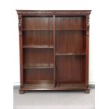 Chinese / Eastern glazed bookcase with adjustable shelving, moulded frieze and lion caryatids,