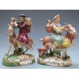 Pair of 19thC Staffordshire figures of the tailor and his wife riding goats