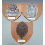 Three replica fire mark insurance plaques on oak shields with notes attached including Yorkshire