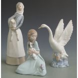 Lladro figurine girl with lamb and two Nao figures, tallest 27cm