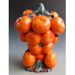 An unusual continental majolica jug in the form of a bunch of tangerines,the handle in the form of a