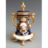 Coalport lidded vase, the four gilt pad feet leading to a tapered body hand decorated cartouche