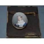 A 19th century portrait miniature on ivory of a lady with a lace collar inscribed verso Mrs C.