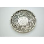 Chinese white metal pin dish with inset coin, further decorated with a dragon and a phoenix, 10cm