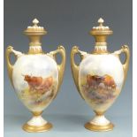 Royal Worcester pair of pedestal twin handled covered vases decorated with Highland cattle in