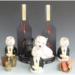 Three Sandland Martell brandy figural water jugs, Black and White whisky advertising figure, two '