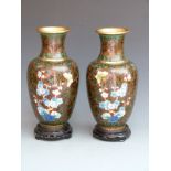 A pair of Japanese cloisonné vases on hardwood stands, 33cm tall