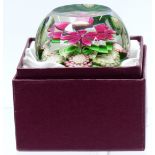 Perthshire faceted glass paperweight with central pink flower with green foliage and cane signed P