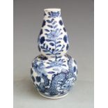 Chinese blue and white double gourd vase with floral and dragon decoration and Kangxi mark to