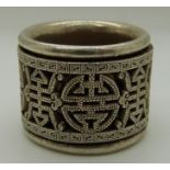 Chinese white metal thumb ring with rotating outer decorated ring, etched and pierced with symbols