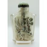 A Chinese reverse painted glass scent bottle with a jadeite cabochon to the stopper, 8.5cm tall