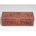 A 19th/20thC carved hardwood Chinese box decorated decorated with court scenes, 24.5 x 9.5 x 7cm