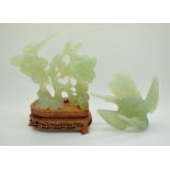 A carved jadeite figure of a bird on a plinth