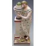 19thC Staffordshire creamware figurine of a lady beside a pedestal jardiniere