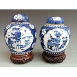Two Chinese ginger jars and covers, one 19thC, the other 19th/20thC, both on carved hardwood