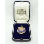 Hallmarked silver and enamel football medal with HMS Pembroke banner below crown and flag to