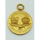 A 9ct gold Inter-service Association Football medal with eagle below two crowns, engraved verso