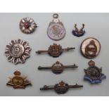 A small collection of silver and enamel Regimental badges etc to include Army Cyclist Corps, West