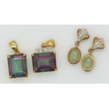 Two 9ct gold pendants set with mystic topaz, and two yellow metal pendants set with a quartz