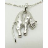 COLLECTING An 18ct white gold pendant in the form of a leopard set with diamonds, on an 18ct white