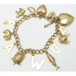 A 9ct gold charm bracelet with various charms including an elephant, turtle, fish, Victorian heart