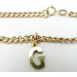 A 9ct gold curb link chain with 9ct gold letter G pendant, 7.1g