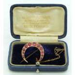 A 9ct gold crescent brooch set with graduated paste and diamonds, in original Cheltenham box