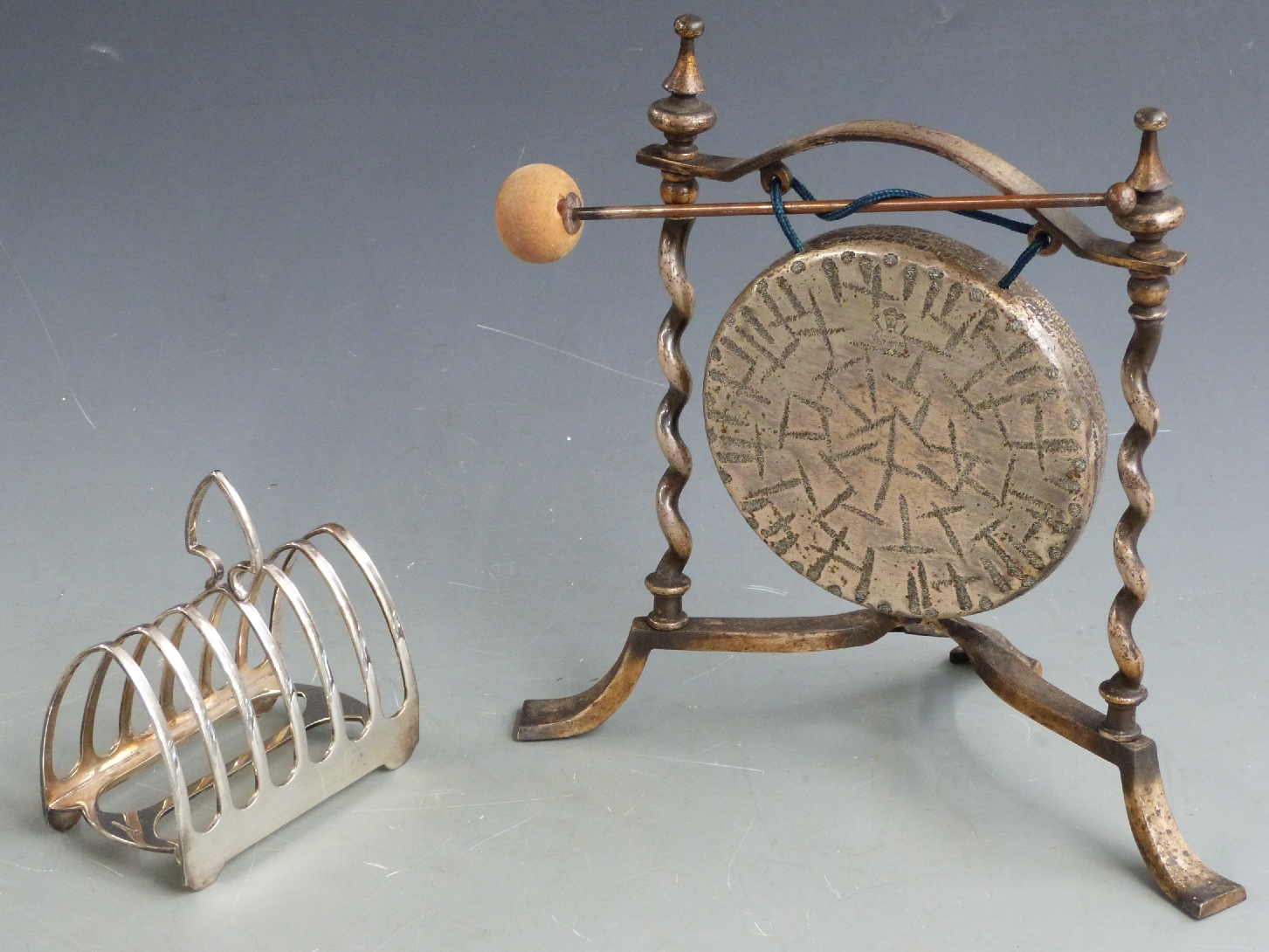 Elkington silver plated seven bar toast rack together with a plated Burmese dinner gong, diameter