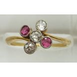 An 18ct gold ring set with three diamonds and two pink sapphires, 2.8g, size N