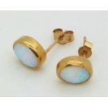 A pair of 9ct gold earrings set with opals