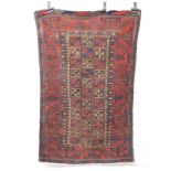 Prayer mat/rug with blue, red and brown checked pattern and intricate border, on a red ground, 142 x