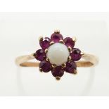 A 9ct gold ring set with an opal and rubies, 2.0g, size M