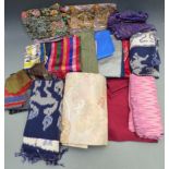 A collection of textiles including Chinese top, Japanese belt, Thai cloth, batiks etc