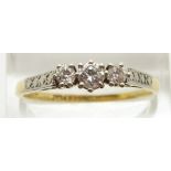 An 18ct gold ring set with three diamonds in a platinum setting, 3.1g, size W