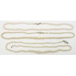 A single strand of cultured pearls with a 9ct white gold clasp, and two single strands of cultured