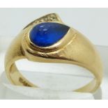 A 14k gold ring set with a blue cabochon and a diamond, size Q, 4g.