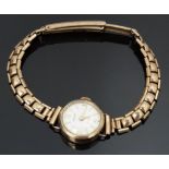Baume 9ct gold ladies wristwatch with gold hands and hour markers, silver dial and 17 jewel
