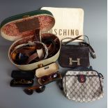 A collection of handbags including a large clutch bag with applied Moschino, Righini and Gucci