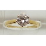 An 18ct gold ring set with a round brilliant cut diamond measuring approximately 1ct, 3.3g, size M