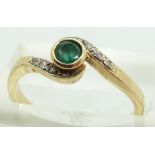 A 9ct gold ring set with an emerald and diamonds, 2.2g, size N