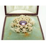 Georgian/ Victorian brooch set with seed pearls and a central foiled amethyst, in original box