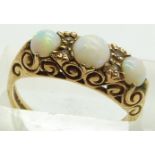 A 9ct gold ring set with opal cabochons, 3.6g, size N