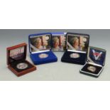 Four cased silver commemorative coins, two being proof examples, all with certificates