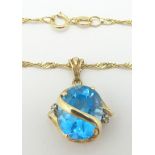 A 9ct gold necklace set with a blue topaz and diamonds, 4.1g