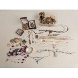 A collection of costume jewellery including silver bangle, silver ingot, silver necklaces etc