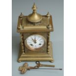 French brass cased two train mantel clock with enamel painted dial, 29cm tall