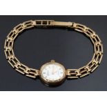 Swiss 9ct gold ladies wristwatch with gold hands and baton markers, silver dial and quartz movement,