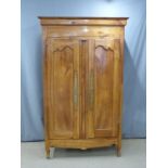 French fruitwood armoire with shaped and panelled doors and pegged joints, W131 x D54.5 x H214cm